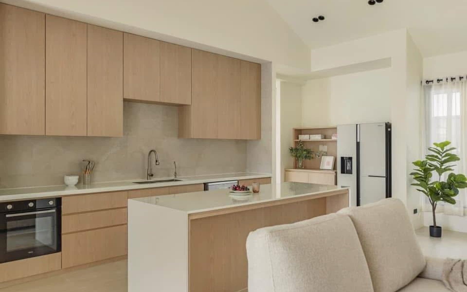 Kitchen renovation with light wood cabinets and island counter
