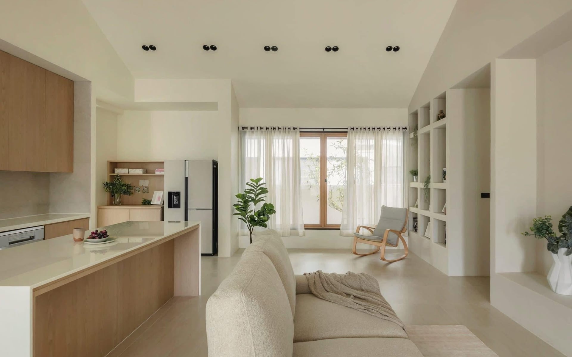 Completed landed living and kitchen interior with connected circulation and built-in storage by LIMM Works
